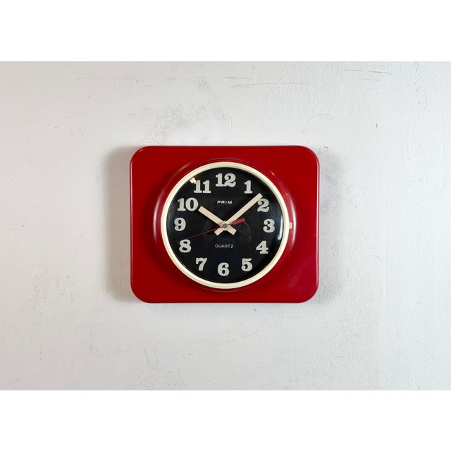 Vintage bakelite wall clock was made by Prim in former Czechoslovakia during the 1970s - 1980s. It features a red plastic...