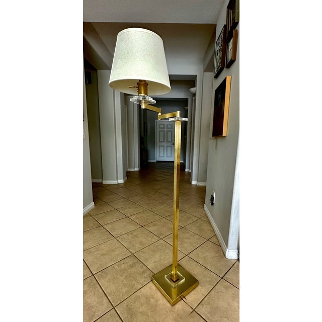 High quality vintage 1970's floor lamp made of solid brass and lucite (acrylic) with swing arm produced by American...