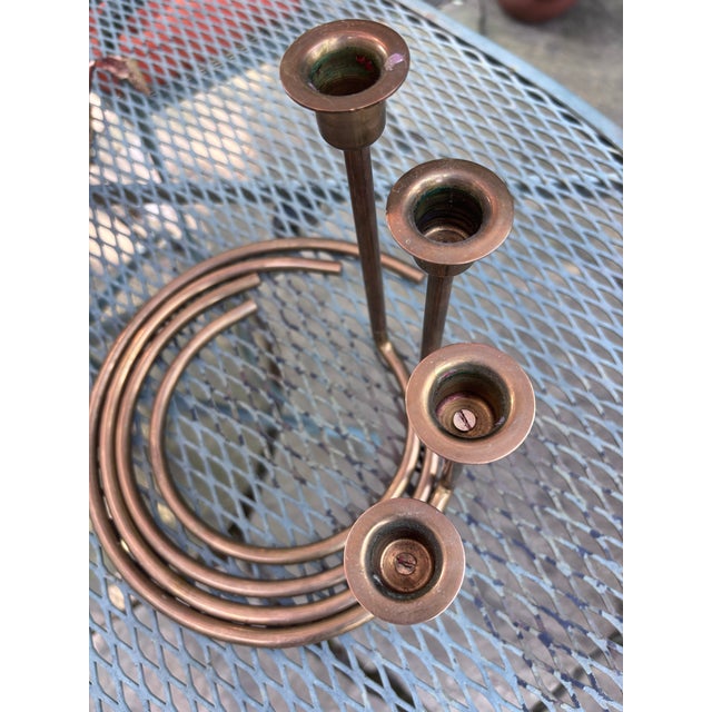 This lovely set of brass candle holders are a beautiful example of minimalist 1960's brass decor. The candle holders swirl...