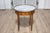 A French Louis XVI style walnut bouillotte table from the 20th century with white and gray variegated marble top, pierced...