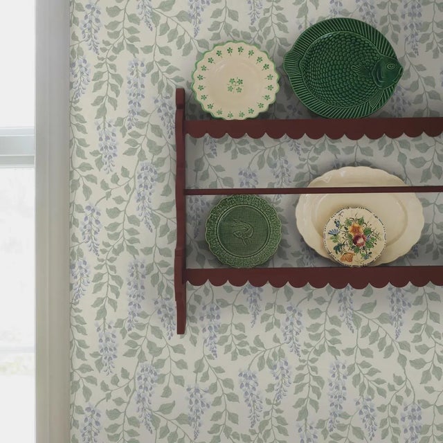 Adorned with trailing wisteria blossoms, Boråstapeter’s Blåregn wallpaper captures the delicate beauty of a springtime...