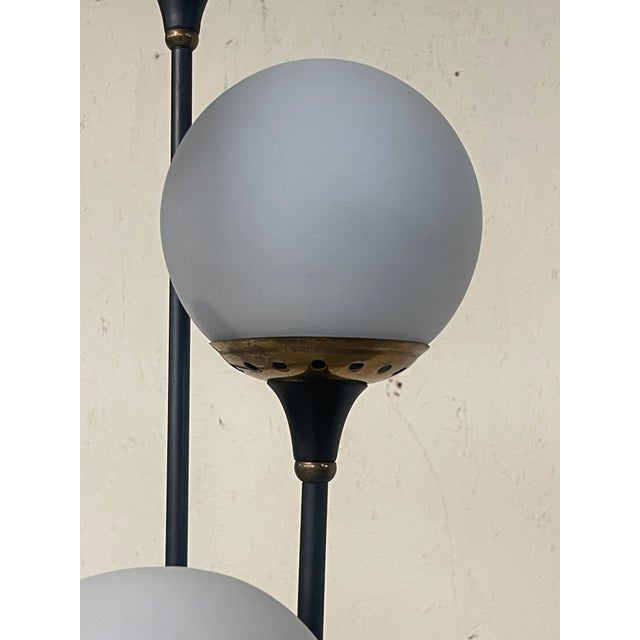 The conical "Alberello" floor lamp, a classic of mid-century Italian design produced by Stilnovo, stands out for its...