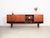The sideboard was made in the 1970s, Danish production. The structure is covered with teak veneer. Legs made of solid wood...