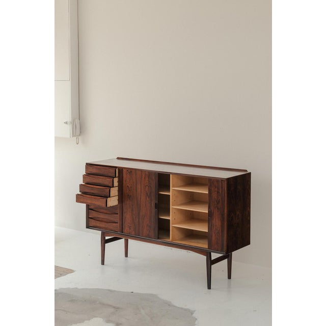 OS36 sideboard designed by Arne Vodder and produced by Sibast in Denmark around 1960. This piece in rosewood veneer opens...