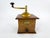 An attractive early 20th-century French manual coffee grinder by Peugeot Frères, featuring a traditional wooden body, a...