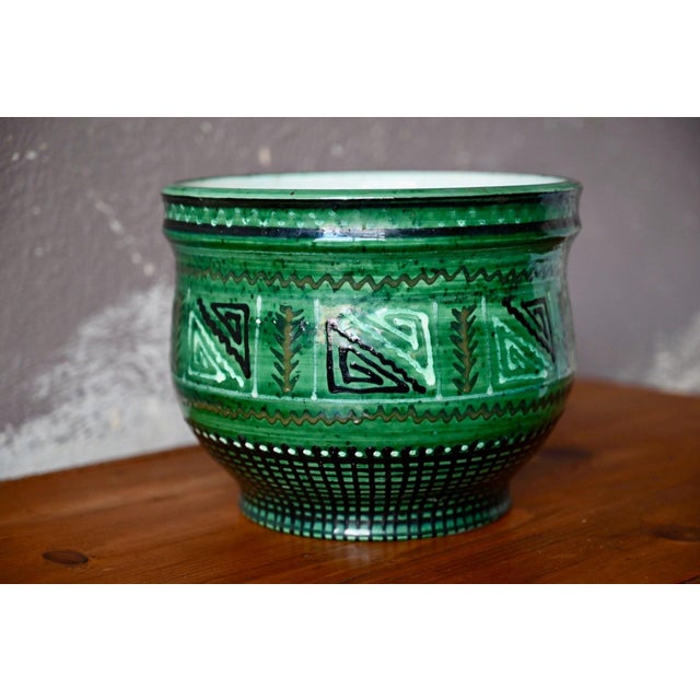 This piece has a truly unique character and undeniable presence! This glazed ceramic cachepot, dating from the mid-20th...