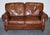 A handsome Halo / Timothy Oulton style Balmoral two seater sofa, upholstered in rich brown heritage leather with a...