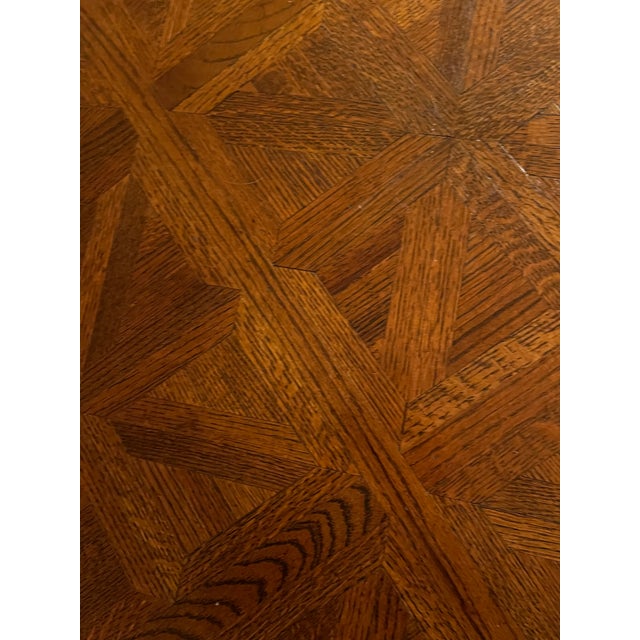 Game table includes a round wooden table with a geometric parquetry veneer top. The four matching armchairs have woven...