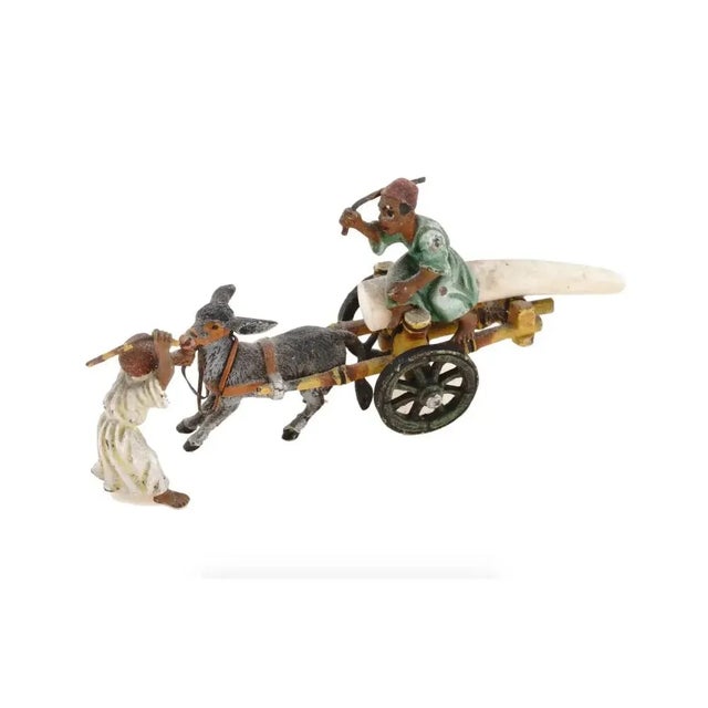 A Vienna Oriental manner cold painted cast bronze and natural materials figural group. The figural group depicts a scene...