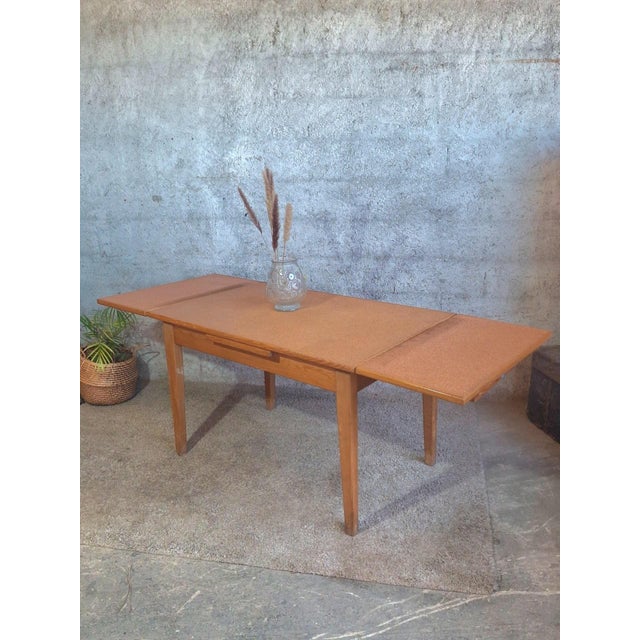 A superb French dining table from the 1950s-1960s, an authentic example of the functional and welcoming style of the post-...
