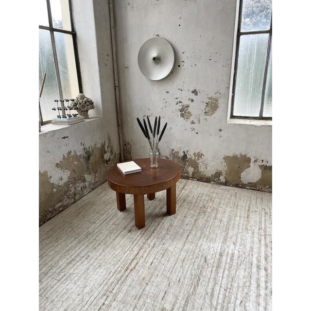 Old table from the 1950s with its circular top cut from the mass of the trunk. Its brutalist appearance, with the...