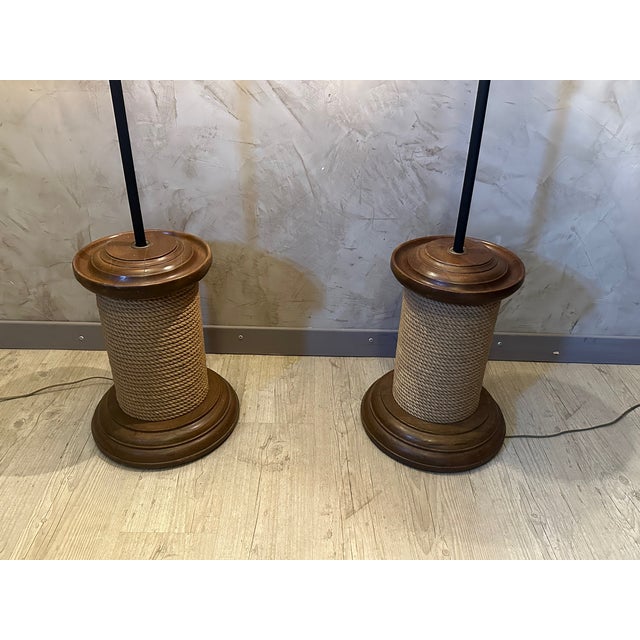 Pair of floor lamps made from fake spools of rope and mounted with beautiful black lampshades and copper interior....