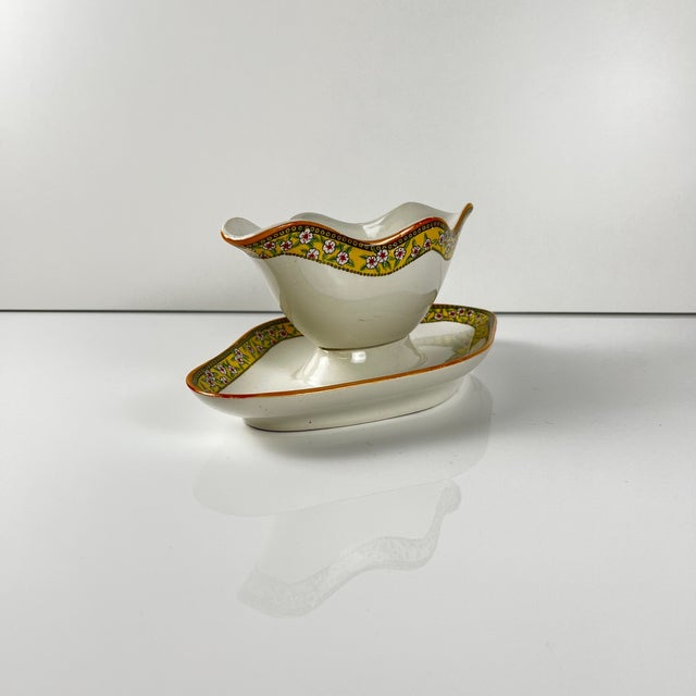 "Yvonne" ironstone sauceboat, Orchies, early 20th century Yellow transfer pattern with small flowers Dimensions: 24 x 14...