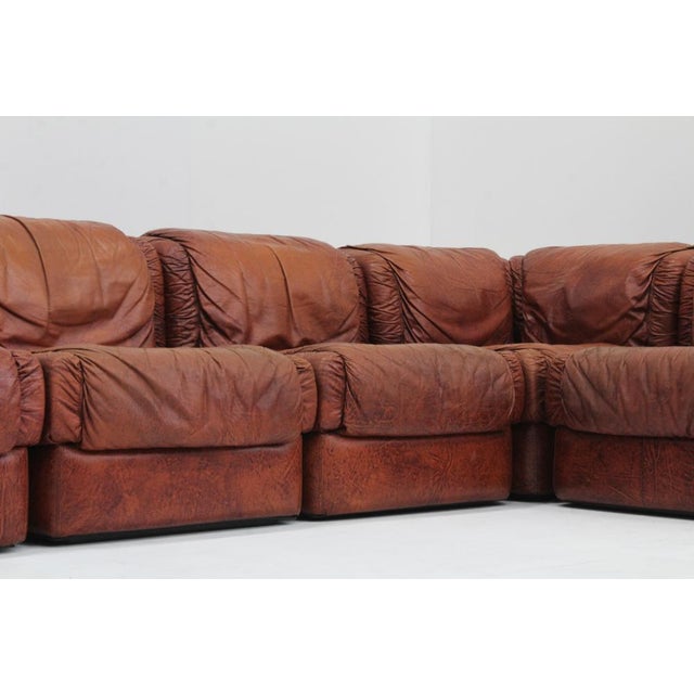 Vintage Seven Salotti Modular Sofa in cognac / burgundy leather designed in Italy in the 1970s. Large sectional lounge...