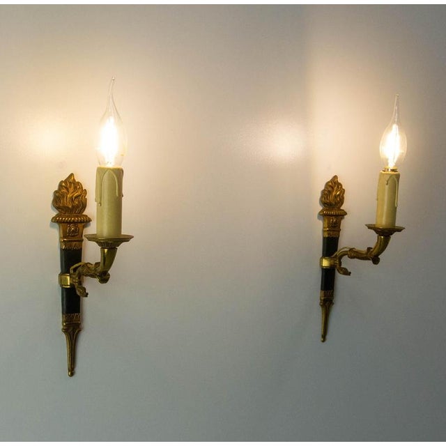 Pair of wall lights with a design typical of the Empire style. The Empire style became popular in France and Europe during...