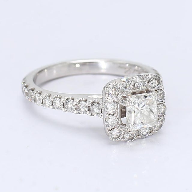 This gorgeous halo engagement ring made in 18k white gold and set with a multitude of diamonds. However the center ~.5ct...