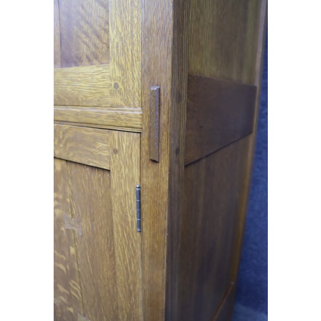 Solid oak cabinet by Stickley in a classic Mission / Arts & Crafts design. Features four paneled doors with exposed...