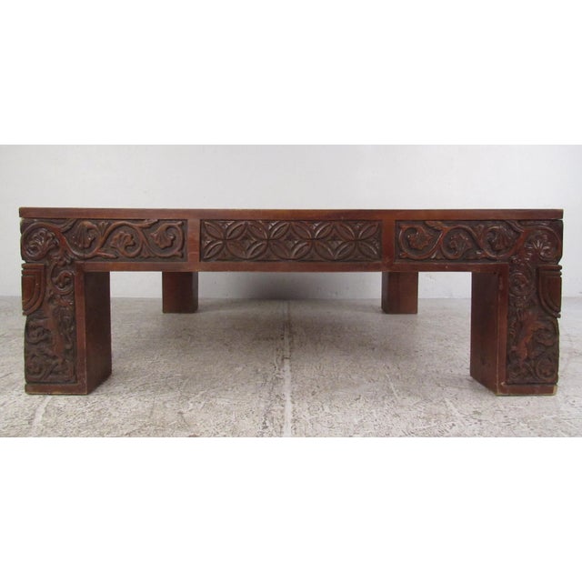 This unique vintage table features an ornate carved frame with an inset marble top. Unique decorative style makes this...