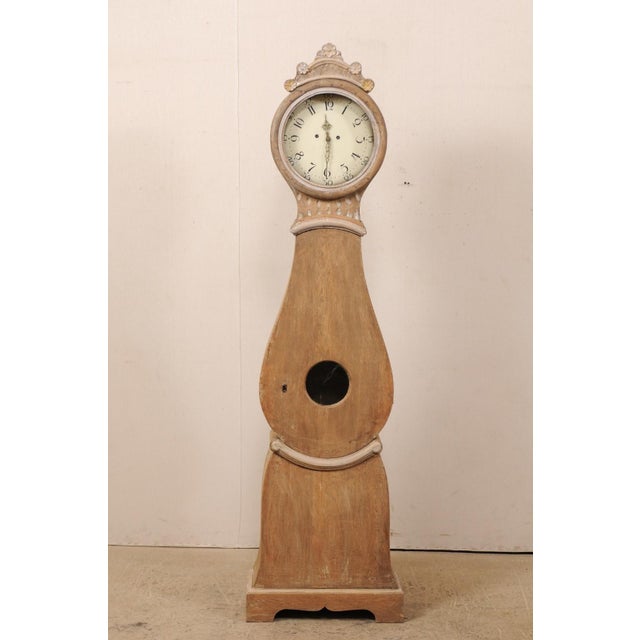 A Swedish grandfather clock from the 19th century. This antique floor clock from central Sweden features a lovely raised...