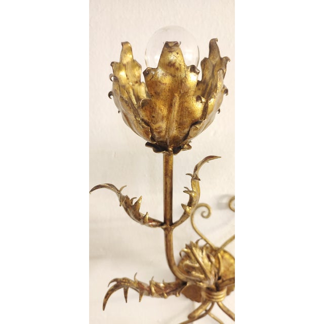 Wrought Iron Gold Leaf Wall Light. France, 1970s, in Restored conditions. Designed 1970 to 1979 European Plug (up to...