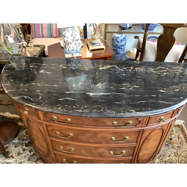 Vintage walnut demilune cabinet/sideboard, with Black marble top. 6 drawers with two side cabinets. Brass hardware.