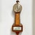 Handsome Sessions banjo clock features elegant golden wood with natural patina brass accents. The Americana aesthetic is...