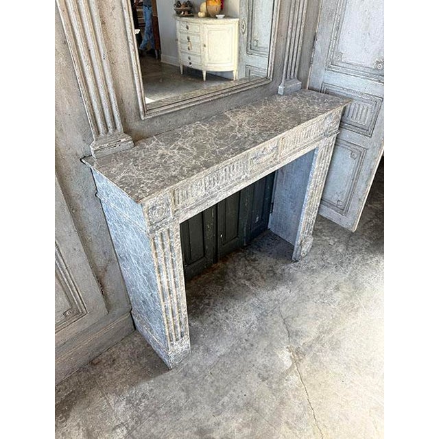 Late 19th C. French Louis XVI style carved wood boiserie featuring mantel and mirror with flanking pairs of doors. This...