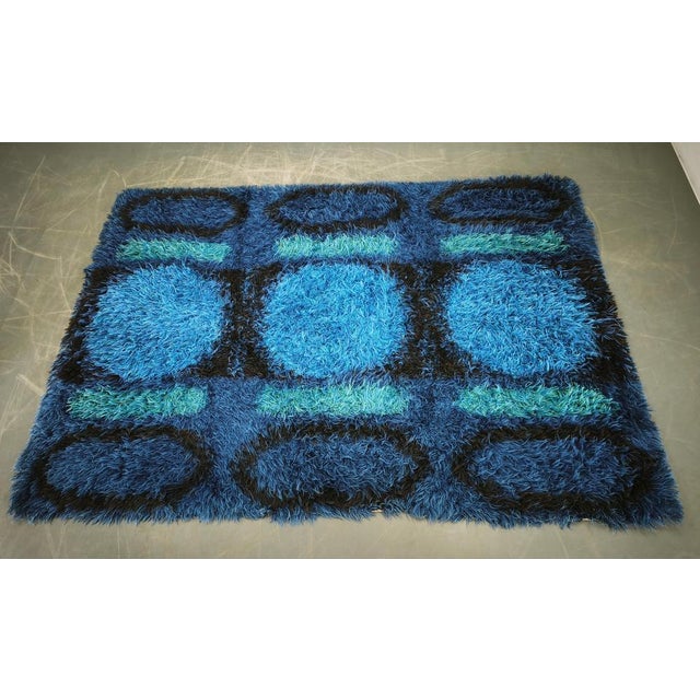 Large-scale Danish Rya rug showcasing a bold abstract geometric design rendered in rich shades of cobalt blue, turquoise,...