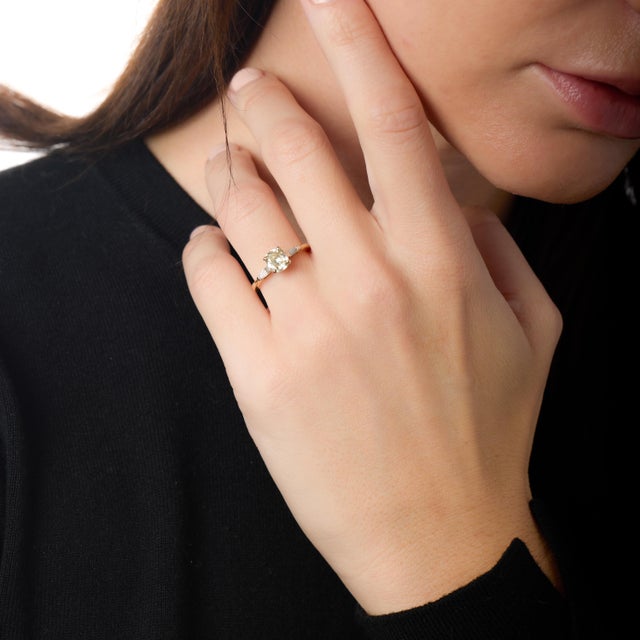 This striking modern engagement ring is defined by individuality and character, centered around a truly rare GIA-certified...