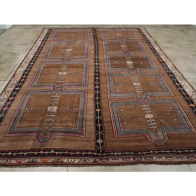 A wool pile of symmetric knots on a wool foundation. This exceptionally large geometric Kars carpet features two columns...