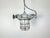 This industrial light was manufactured in Poland in the 1980s. It features a grey cast iron body, an iron cage and an...