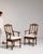 A dining chair whose dark walnut, pierced fretwork splat gives it real character at first glance. It was made in France...
