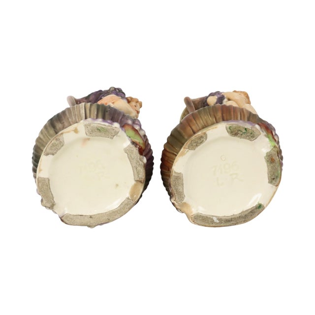 Beautiful pair of glazed earthenware Art Nouveau vases in the shape of a tree stump, featuring putti or cherubs and...