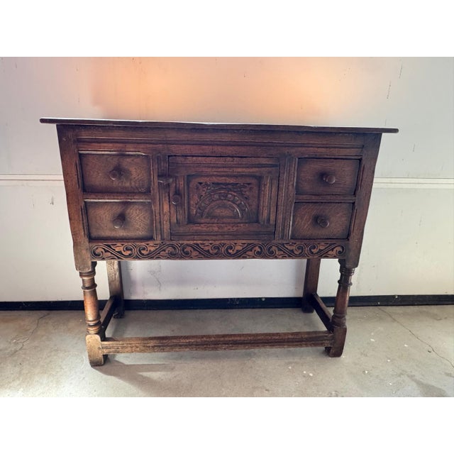 Manufactured by Teeangee of Ipswich, England. Believed to be crafted of solid oak, this charming English side cabinet...