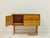 This charming vintage chest of drawers from the 1960s impresses with its clean, mid-century design and warm combination of...