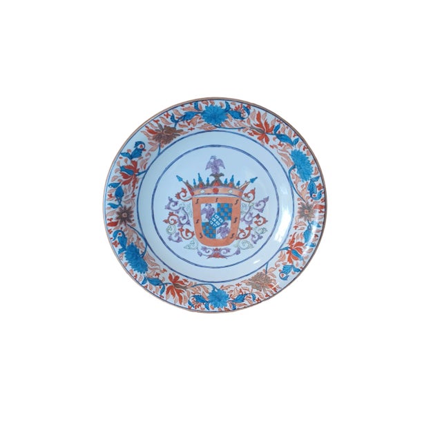 Pair of large vintage porcelain arboreal plates . Plates have coat of arms in center with floral decoration around rim....
