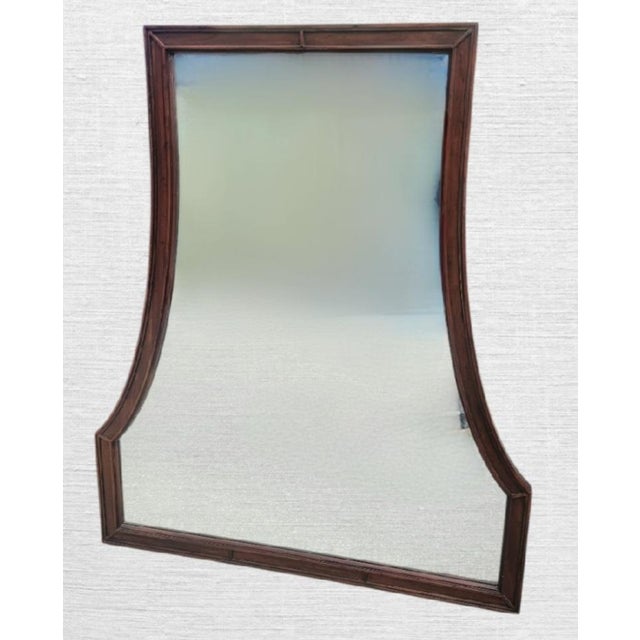 A beautiful wood framed pagoda design large wall mirror. The mirror has a nice simple and elegant stained wood surround....