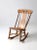 This antique rocking chair features a graceful fiddleback silhouette with a hand-painted landscape motif adorning the...