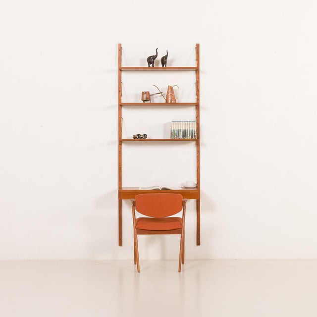 The danish home office teak shelving unit with a desk is reminiscent of the iconic 1960s modular furniture designed by...