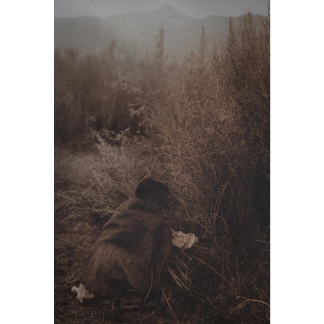 One of the most atmospheric plates in the early volumes of The North American Indian, this photogravure depicts an Akimel...