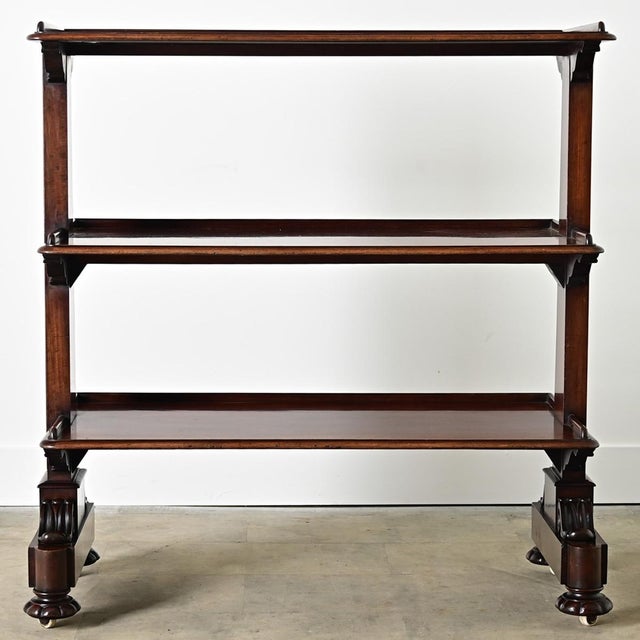 An exceptional serving trolley in the Regency style, from 19th century England, made of dark mahogany which brings a sense...