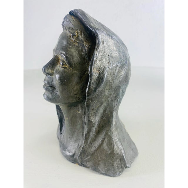This is an early 20th century solid zinc sculpture of a woman. This early 20th century French sculpture depicts a bust of...
