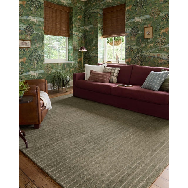 The Henry Collection from Chris Loves Julia x Loloi is a hand-tufted area rug that adds a touch of personality to a solid-...