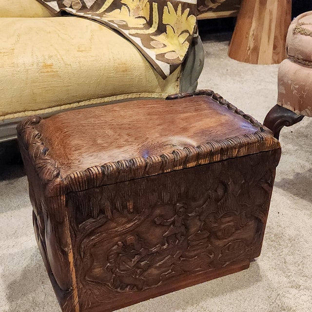 Elevate your space with this masterfully hand-carved wood keepsake trunk. Featuring a detailed bas-relief scene of a man,...