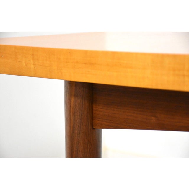 A mid century modern maple top dining table with walnut legs made American of Martinsville. Professionally refinished. 60”...