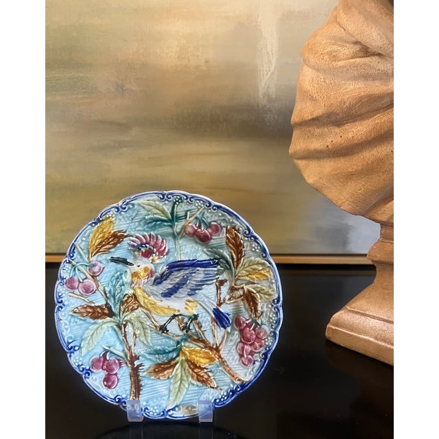 19th century majolica plate hand painted and decorated with a bird leaves and berries, the edging is scalloped. Made in...