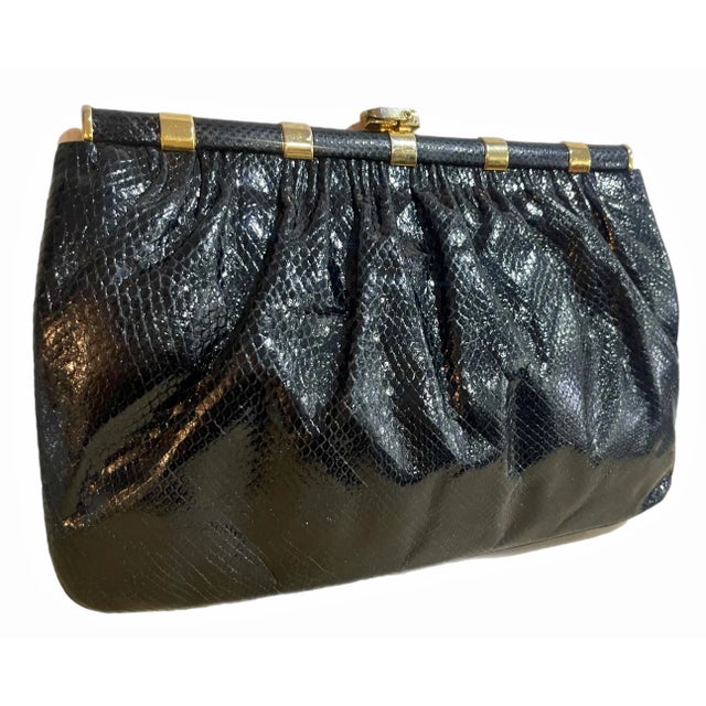 Chic 1980s karung snake clutch with gold tone metal hardware by Finesse La Model. Comes with matching gold comb and...