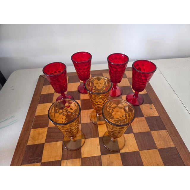 Set of 7 Thick barware glasses. 3 amber colored and 4 ruby red. In good condition.