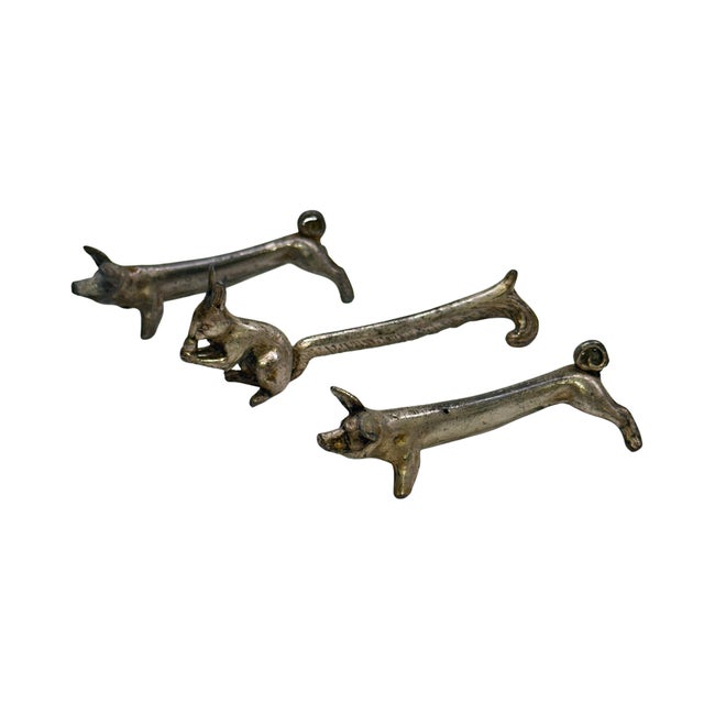 A charming set of six vintage figural animal knife rests, each cast in metal with an aged, darkened patina. The collection...