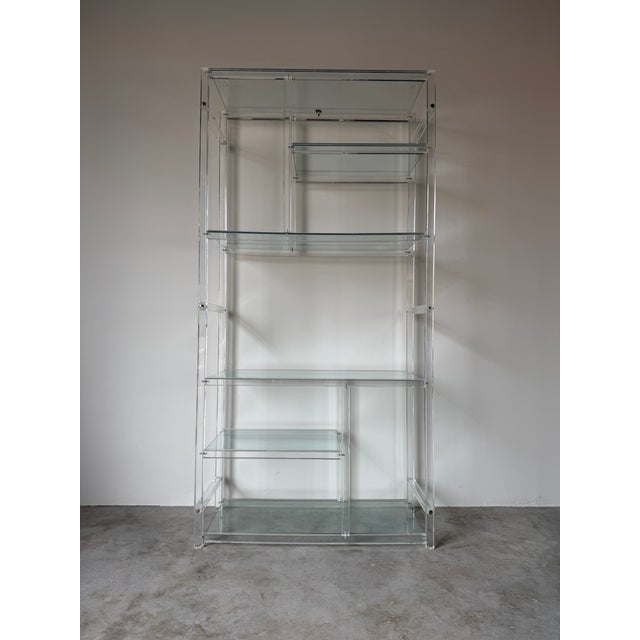 Striking vintage 1960s six-tier étagère in the style of Charles Hollis Jones, featuring a sculptural clear Lucite frame...